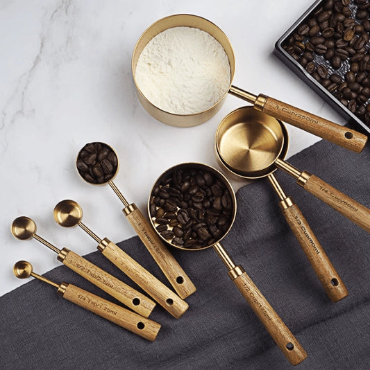 Upgrade your kitchen tools with our Gold Stainless Steel Sets! ✨ Made from heavy-duty, food-grade stainless steel, these measuring utensils are rust-proof and a healthier alternative to plastic. Perfect for both liquid and dry ingredients, they feature engraved measurement marks for precise cooking.

The special walnut handles ensure a non-slip grip, making them comfortable to use. Elevate your baking experience with this luxurious and functional set!